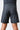 Model wearing black GB Essentials Velcro Training Shorts, back view showing red side panel accents