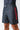 Angled side view of black GB Essentials Velcro Training Shorts on model with red Barra side print