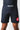 Man wearing black GB Essentials velcroless training shorts, front view with white Gracie Barra wordmark on the waistband and red triangle logo on the left leg