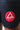 Close-up of the round red and white Gracie Barra triangle logo patch on the leg of the black training shorts