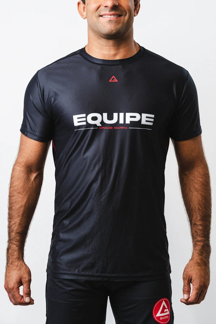 Man wearing the black GB Essentials Mesh Training Tee, front view showing the white EQUIPE chest print and red Legacy G