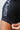 Close-up of the longer sleeve with grey Gracie Barra print and red stitched hem being held by a hand