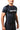 Man in the black GB Essentials Ranked Rashguard turned to the side, showing the textured side panel and underarm seam-free construction