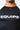 Close-up of the chest area showing the red Gracie Barra triangle logo, white EQUIPE print and seamless neckline of the rashguard