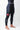 Three-quarter front view of the black GB Essentials Womens Compression Pants with the red Barra Shield patch above the knee.