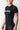 Angled side-front view of the black GB Essentials Womens Ranked Rashguard, showing the textured side panel, tonal Gracie Barra sleeve print and EQUIPE chest graphic