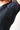 Detail shot of the seamless underarm side panel on the black GB Essentials Womens Ranked Rashguard, with geometric triangle texture and red contrast stitching at the collar