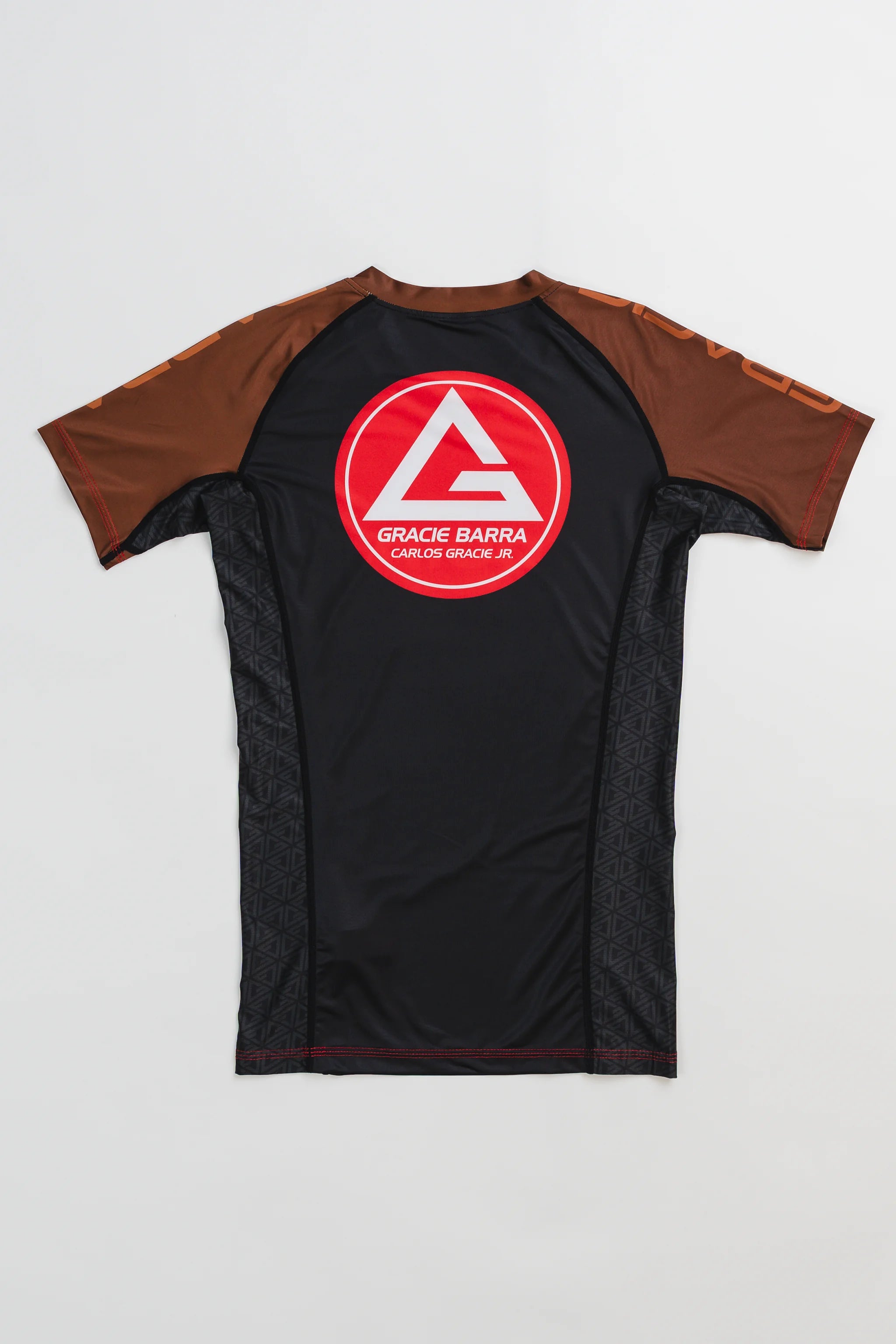 GB Essentials Women’s Ranked Rashguard in black with brown sleeves, featuring the Gracie Barra Red Shield logo on the back.