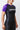 Woman wearing the GB Essentials Womens Ranked Rashguard in purple, angled side view showing Gracie Barra print on the purple sleeve and patterned side panel