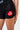 Side view of the black Close Contact Womens Compression Pants showing the white Gracie Barra print on the gray striped hip panel, ankle length.