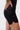 Detail of the red Gracie Barra wordmark on the elastic waistband of the black Close Contact Womens Compression Pants, with gray striped side panels.