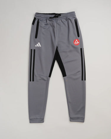 Gray GB Team Track Jogger by adidas with black stripes, red Gracie Barra logo, and drawstring waistband on a light gray background.