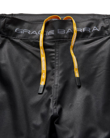 Close-up of elastic waistband on black Gracie Barra x Vanguard Evolution No Gi Shorts with yellow Vanguard drawstring and grey “Gracie Barra” branding.