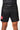 Athlete wearing black Gracie Barra x Vanguard Evolution No Gi Shorts with red Barra Shield logo on right leg and grey “Gracie Barra” waistband branding.