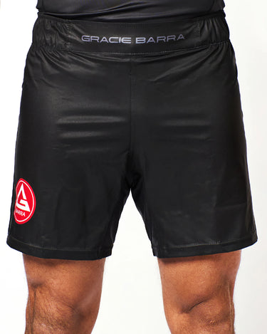 Athlete wearing black Gracie Barra x Vanguard Evolution No Gi Shorts with red Barra Shield logo on right leg and grey “Gracie Barra” waistband branding.
