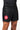 Athlete wearing black Gracie Barra x Vanguard Evolution No Gi Shorts showing red Barra Shield logo on left leg and elastic waistband with branding.