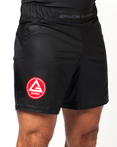 Athlete wearing black Gracie Barra x Vanguard Evolution No Gi Shorts showing red Barra Shield logo on left leg and elastic waistband with branding.