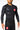 Athlete wearing black Gracie Barra x Vanguard Evolution rashguard with red Barra Shield chest logo, tonal Vanguard sleeve branding, and GB shorts.