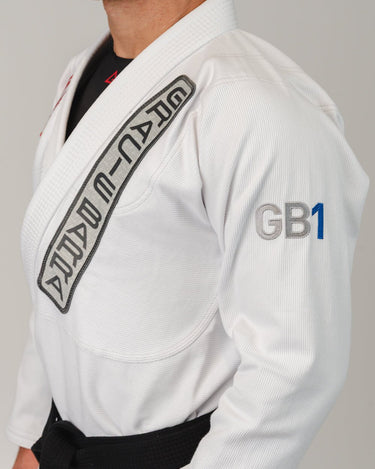 Close-up of the white GB1 Kimono showing the Gracie Barra lapel patch, GB1 arm embroidery, and reinforced jacket construction designed for durability and performance.
