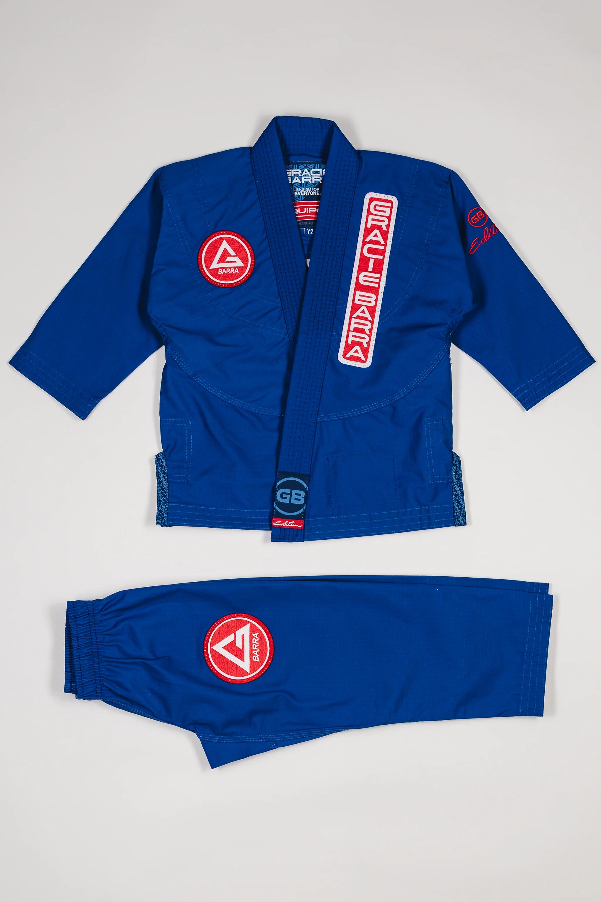 Blue GBK Lite Ripstop kids’ kimono set with Red Shield patches, front view.