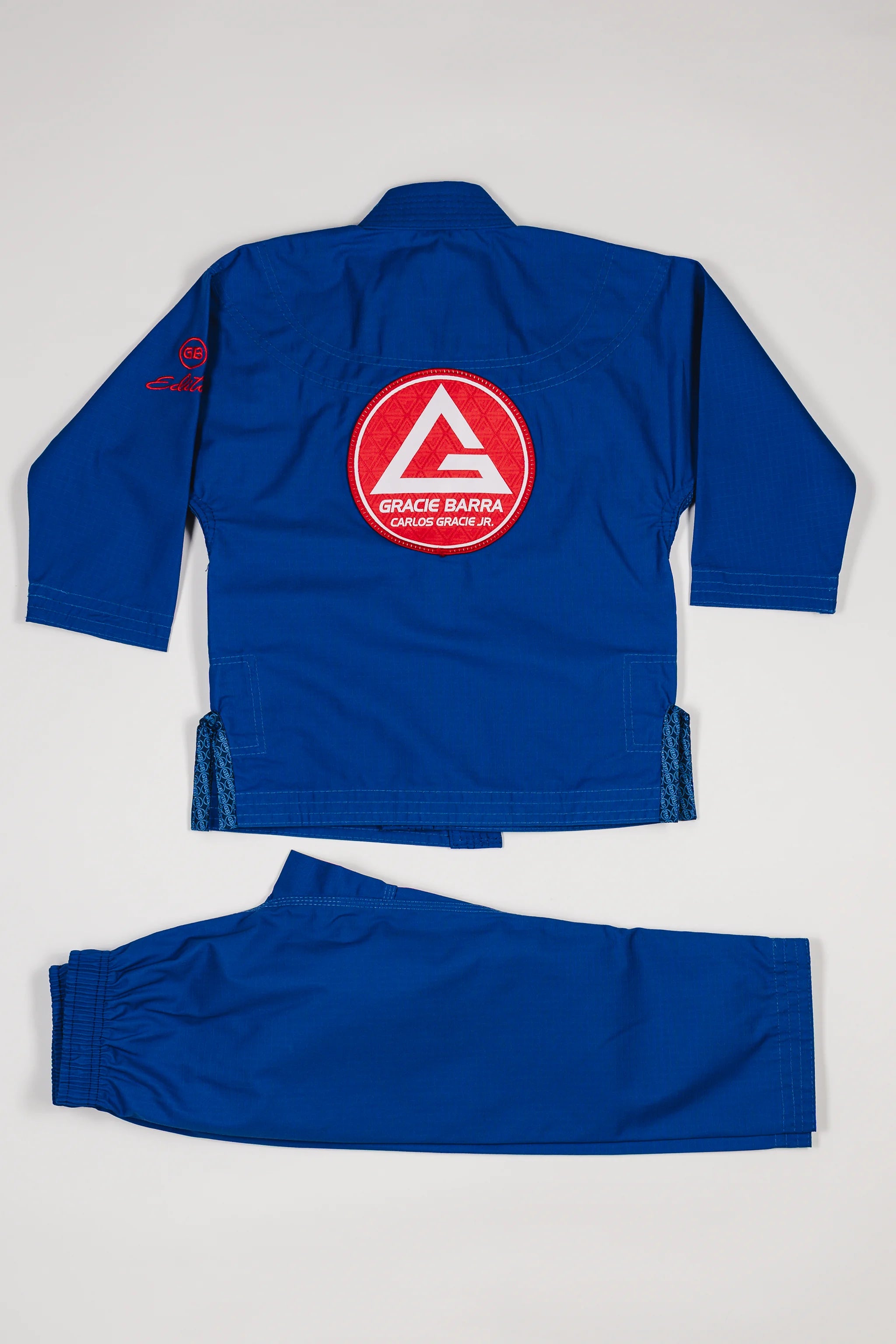 Blue GBK Lite Ripstop kids’ kimono set with large Red Shield patch on the back.