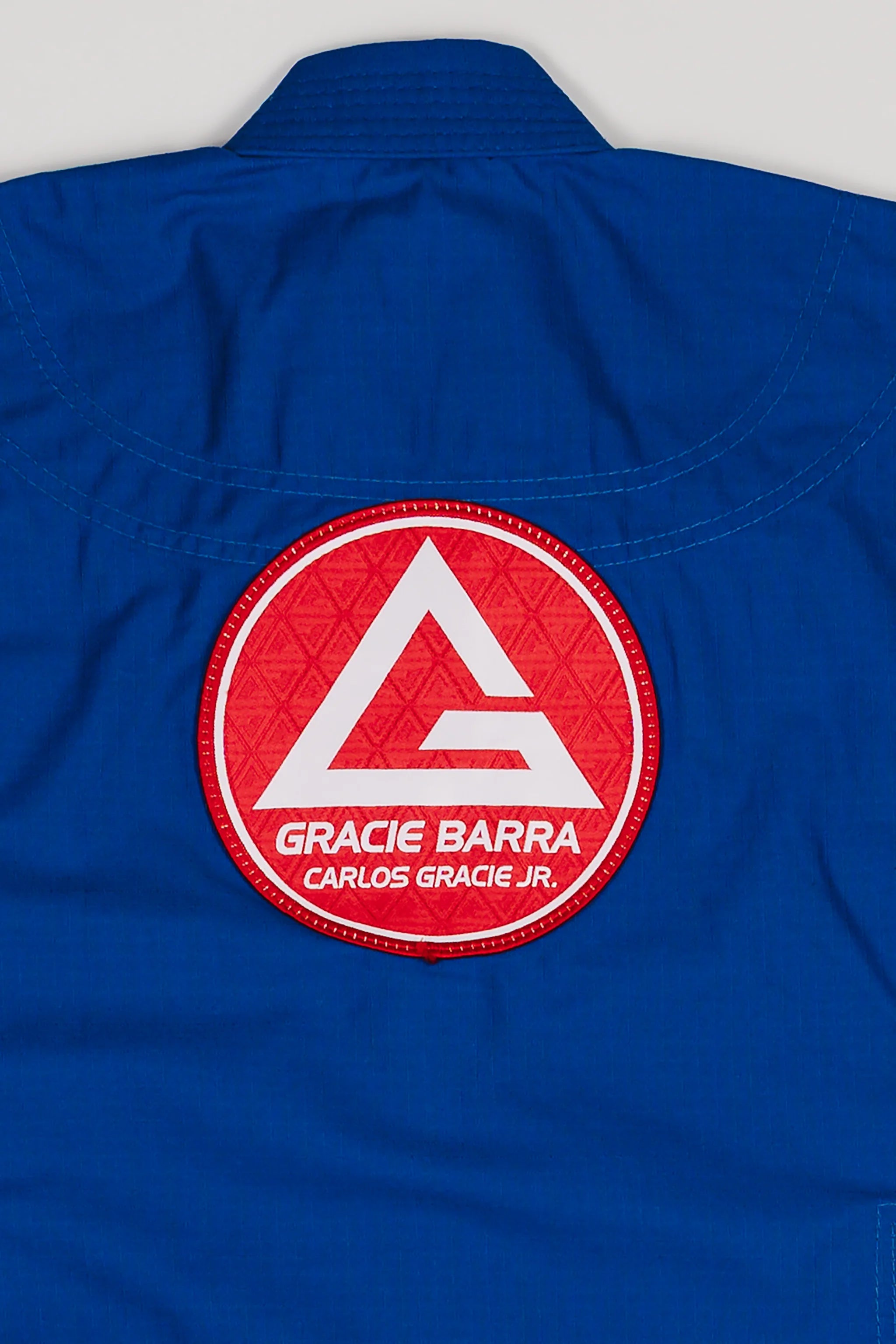 Large Red Shield patch stitched on the back of the blue kids’ kimono.