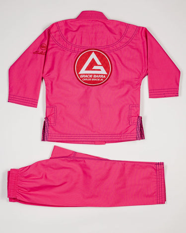 Back view of the pink GBK Lite Ripstop kids’ kimono set with a large Red Shield patch centered on the jacket. Shows the full jacket and pants to help parents see the fit and bright color young girls love.