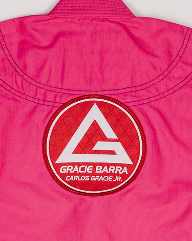Close-up of the large Red Shield patch on the back of the pink GBK Lite Ripstop kimono, highlighting the sturdy stitching and bright color parents appreciate for long-lasting wear.
