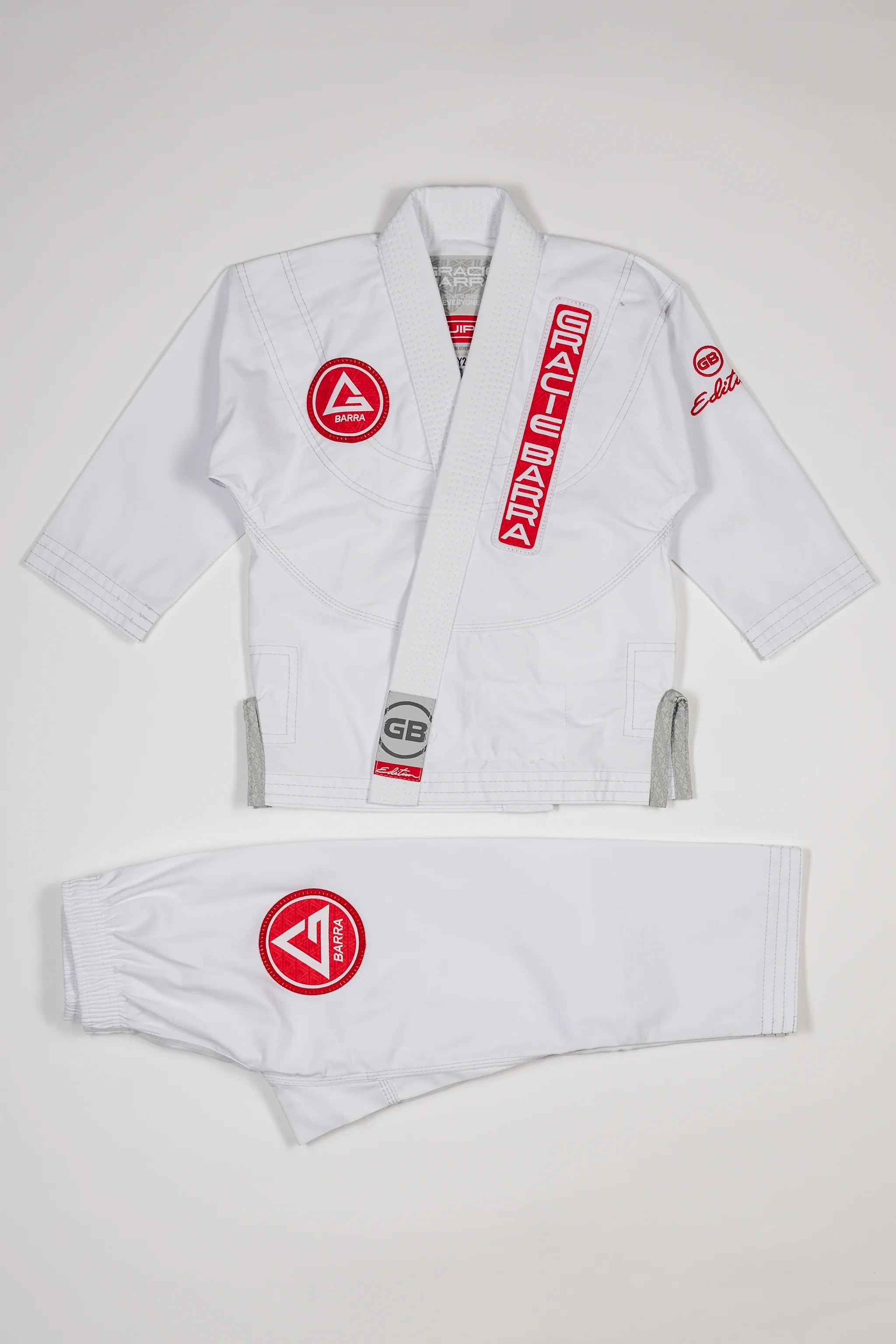 Kids’ white GBK Lite Ripstop kimono set with Red Shield patches, front view.
