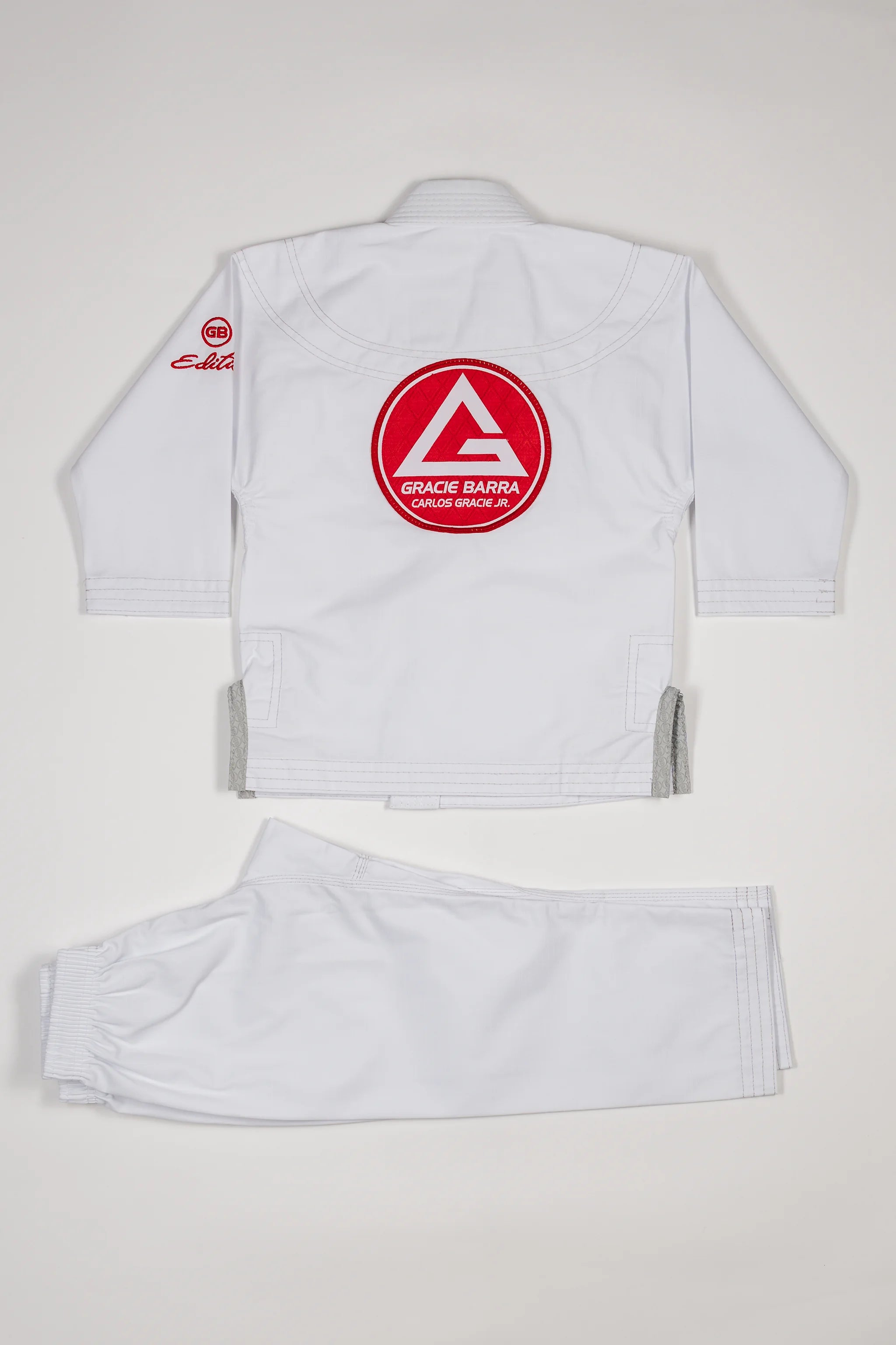Kids’ white GBK Lite Ripstop kimono set with large Red Shield patch on the back.