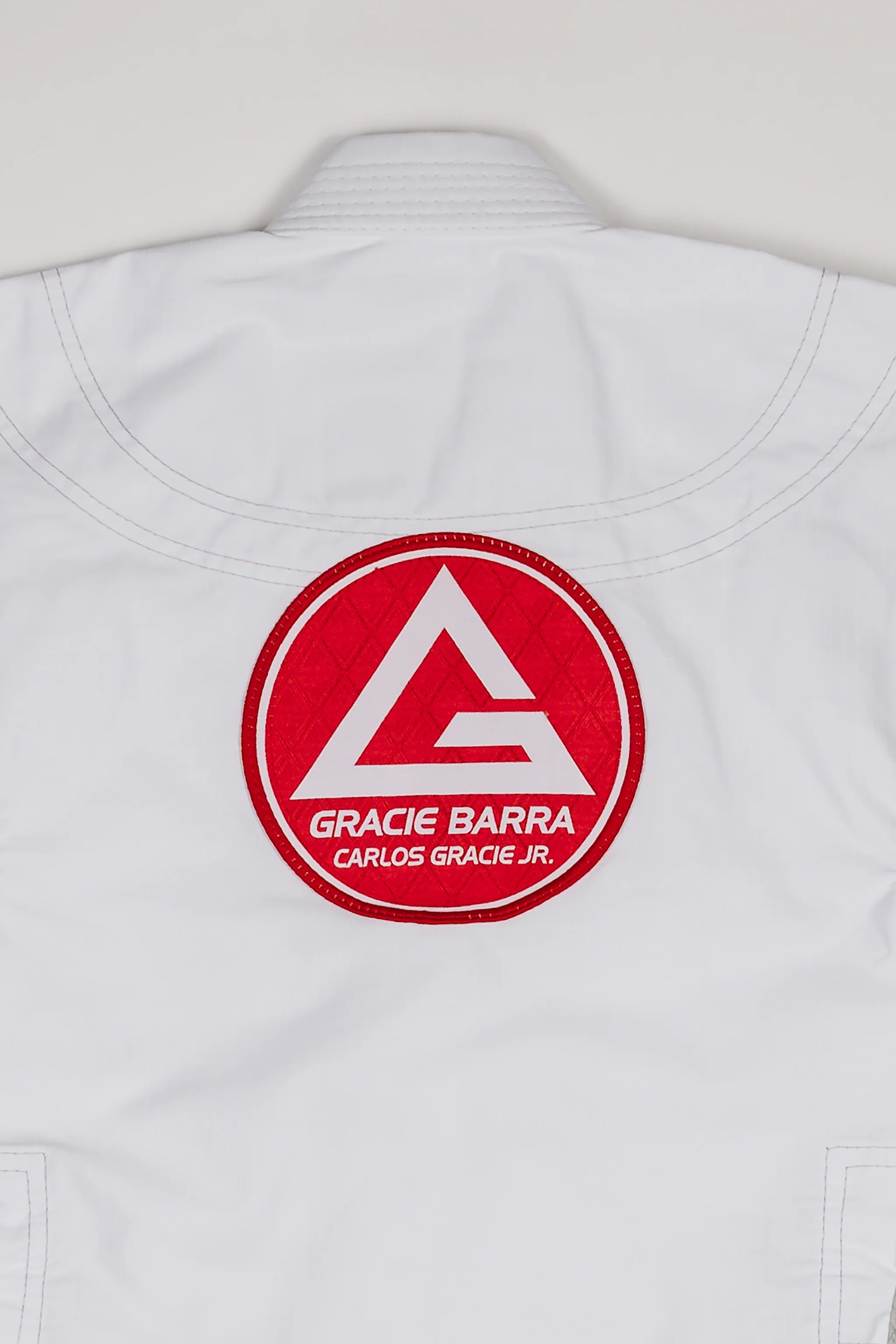 Close-up of large Red Shield patch stitched on the back of the white kids’ kimono.