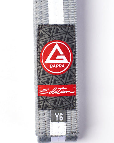 Front view of the grey-and-white youth belt tip featuring the GB Red Shield patch and Edition branding.