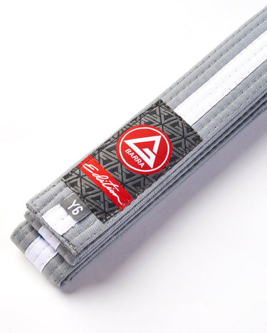 Close-up of the grey-and-white youth belt showing the GB Red Shield patch, Edition label, and size tag.