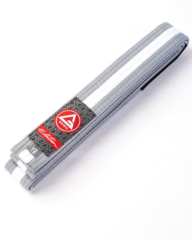 Folded grey-and-white youth martial arts belt with the GB Red Shield label, displayed on a white background.