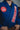 Close-up of blue GB x adidas III Stripes Women’s Kimono showing red Barra Shield patch on chest and red Gracie Barra lapel patch worn during training.