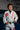 Youth student wearing white GB x adidas III Stripes Kimono with red 3-Stripes and Barra Shield patch, standing on the mats inside a Gracie Barra academy.