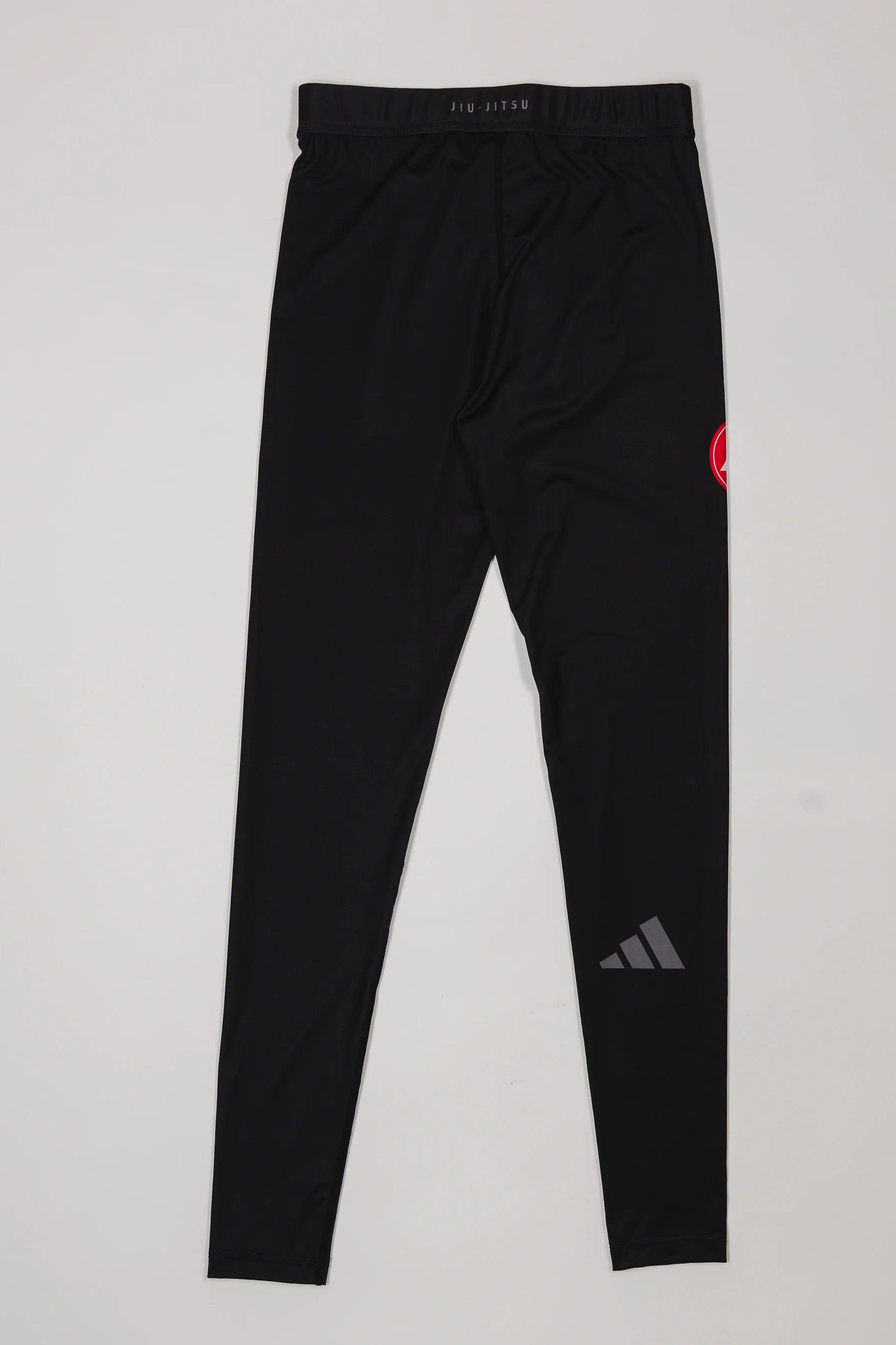 Back view of the GB x adidas III Stripes Compression Pants in black, featuring the Red Shield logo and adidas mark on a light gray background.