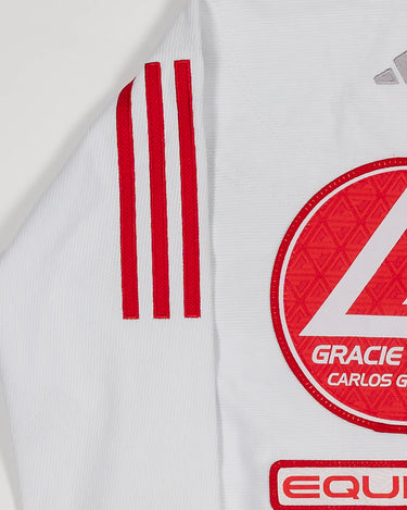 Close-up of white GB x adidas III Stripes Youth Kimono shoulder and back showing red 3-Stripes detail, Red Shield patch, and red EQUIPE GB patch embroidery.