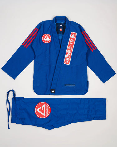 Blue GB x adidas III Stripes Women’s Kimono laid flat on white background, featuring bold red 3-Stripes on shoulders, red Barra Shield on chest, and Gracie Barra lapel patch with adidas Performance embroidery.