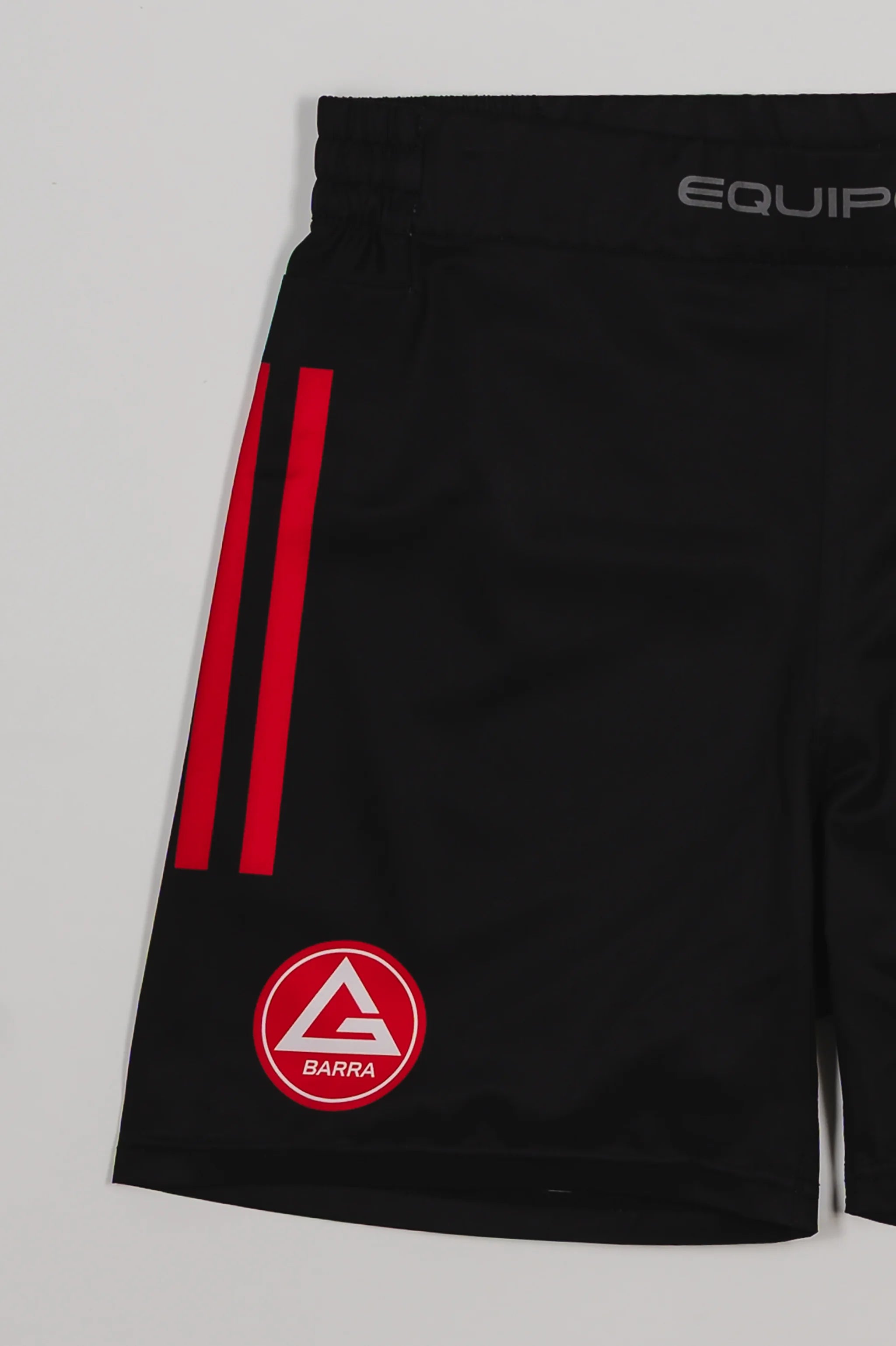 Close-up of the GB x adidas III Stripes Training Shorts in black, showing red side stripes, the Red Shield logo near the hem, and “Equipe GB” waistband detail.