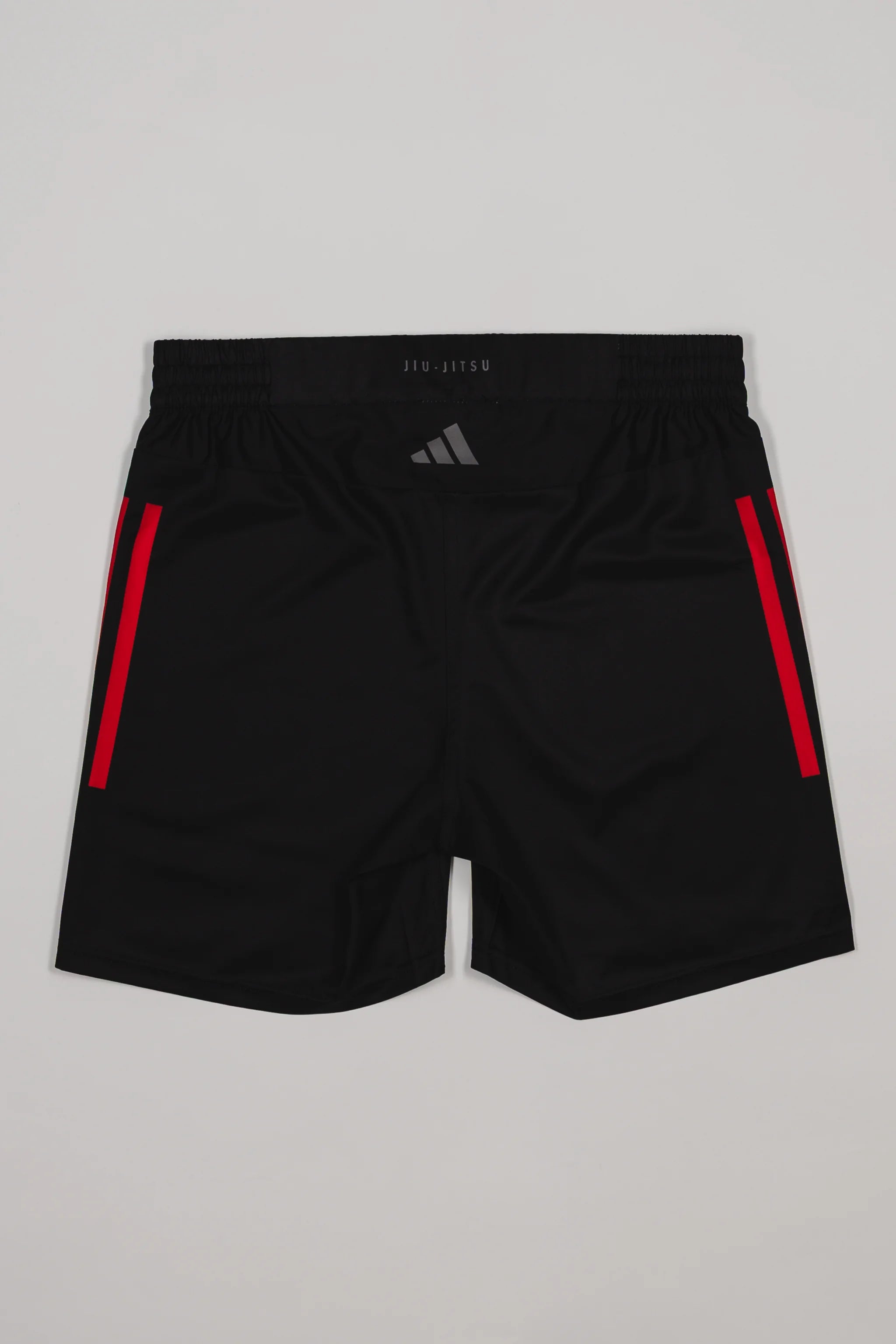 Back view of the GB x adidas III Stripes Training Shorts in black, featuring red side stripes, “Jiu-Jitsu” waistband detail, and adidas logo on the upper back.
