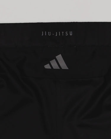 Close-up of the back waistband of the GB x adidas III Stripes Training Shorts in black, featuring the adidas logo and “Jiu-Jitsu” text detail.