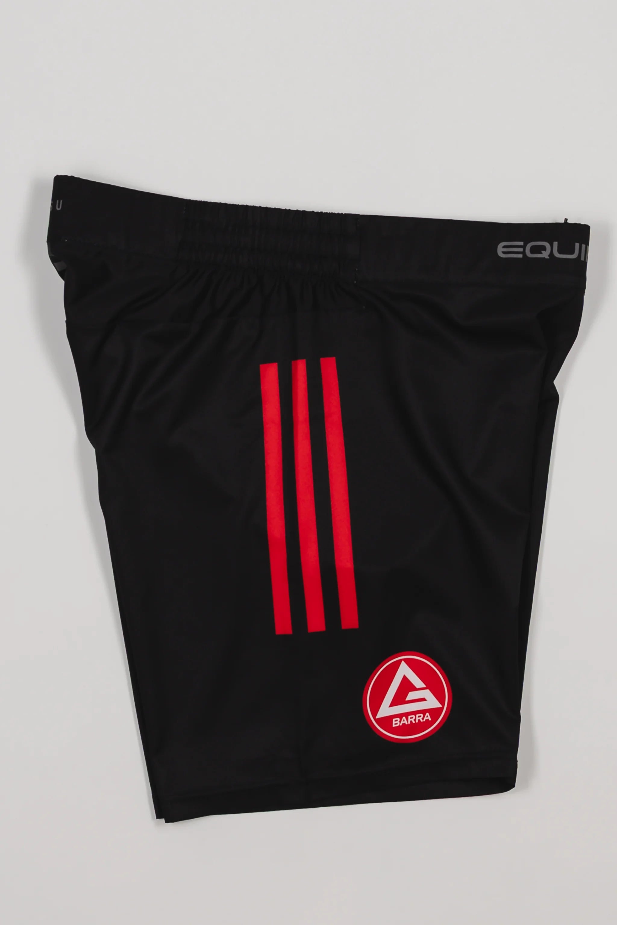 Side view of the GB x adidas III Stripes Training Shorts in black, showing red adidas triple stripes, the Red Shield logo on the leg, and “Equipe GB” branding on the waistband.