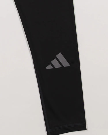 Close-up of the GB x adidas III Stripes Women’s Compression Tights showing the adidas Performance logo printed near the lower leg.