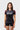 Student wearing the black III Stripes Womens Ranked Rashguard by adidas, with red three-stripe sleeves, red flatlock seams and gray stacked Gracie Barra logo