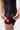 Mesh hem panel with white Jiu-Jitsu print and red contrast flatlock stitching on the black III Stripes Womens Ranked Rashguard by adidas