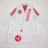 White GB x adidas III Stripes Women’s Kimono laid flat on white background, featuring bold red 3-Stripes on shoulders, red Barra Shield on chest, and Gracie Barra lapel patch with adidas Performance embroidery.