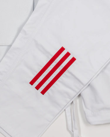 Close-up of white GB x adidas III Stripes Women’s Kimono pants showing embroidered GB Red 3-Stripes detail on the upper leg.