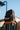 Gracie Barra Jiu-Jitsu kids backpack hanging from a playground rail against a blue sky