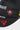 Close-up of the white Stacked Gracie Barra wordmark and red Barrinha patch on the black Jiu-Jitsu Icon youth cap, with the red Legacy G triangle below.